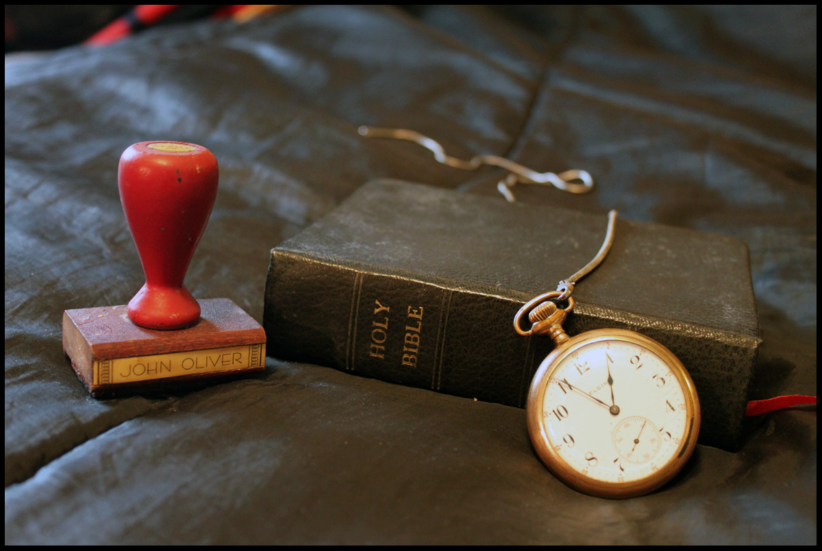 Bible, watch and rubber stamp